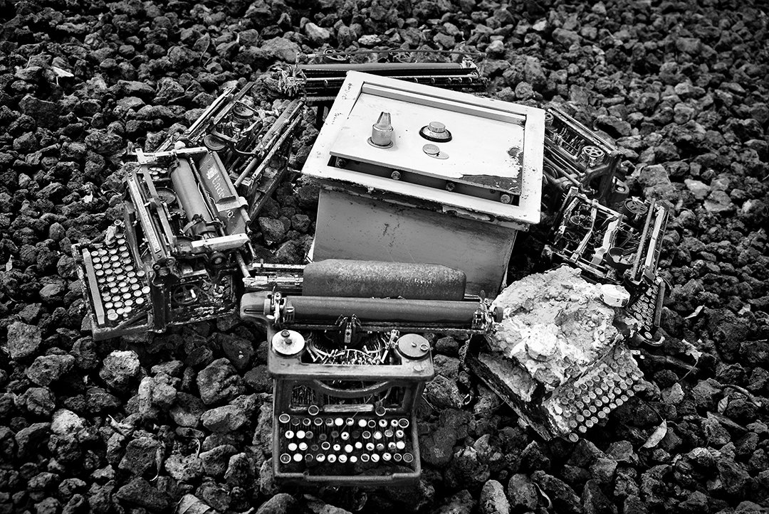 Typewriters and other objects on stones.
